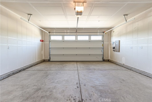 garage with electric panel and a garage door opener