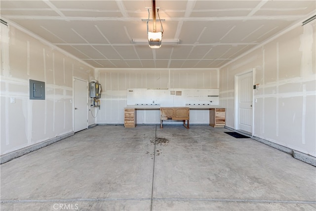 garage featuring a garage door opener, electric panel, and water heater