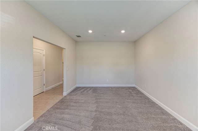 unfurnished room with light carpet