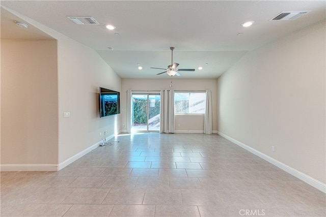 unfurnished room with lofted ceiling, light tile patterned flooring, and ceiling fan