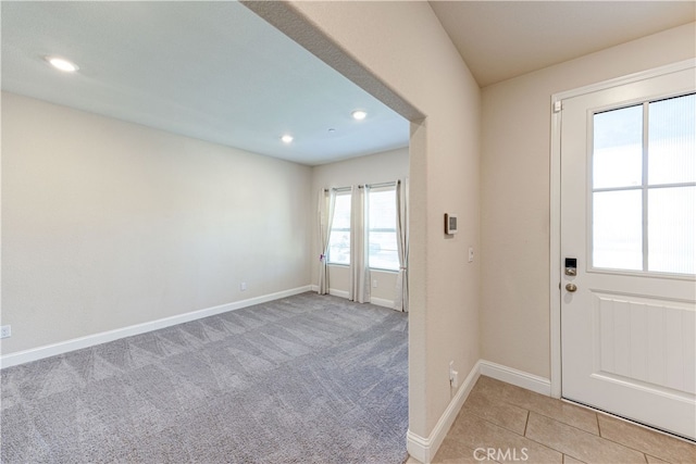 entryway featuring light colored carpet