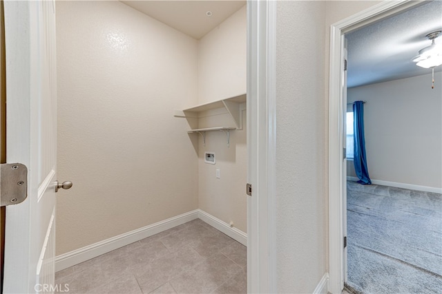 laundry area with light tile patterned flooring and washer hookup