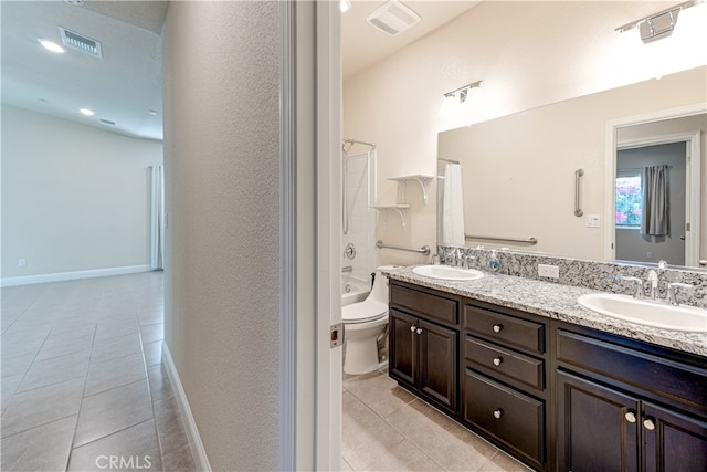 full bathroom featuring shower / bath combo with shower curtain, vanity, tile patterned flooring, and toilet