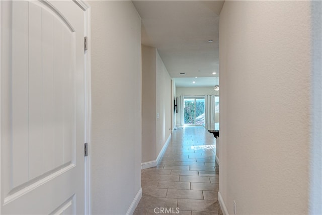 corridor featuring light tile patterned flooring