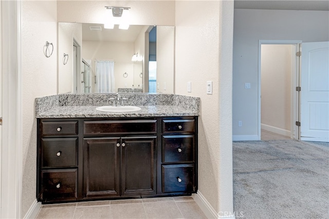 bathroom featuring a shower with curtain, vanity, and tile patterned floors