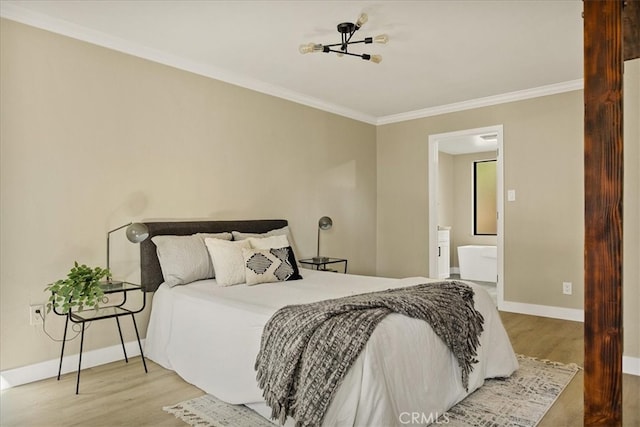 bedroom featuring ornamental molding, connected bathroom, and light wood-type flooring