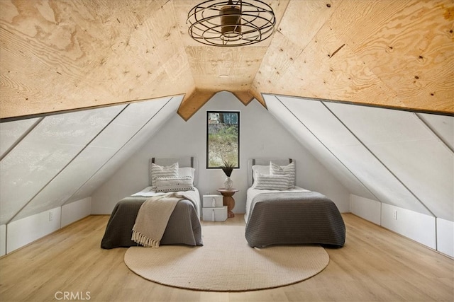 bedroom featuring lofted ceiling and hardwood / wood-style flooring