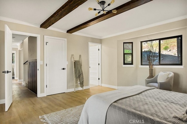 bedroom featuring crown molding, light hardwood / wood-style floors, and beamed ceiling