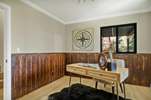 office space featuring wood walls, light hardwood / wood-style floors, and ornamental molding