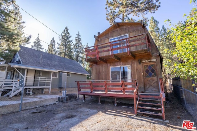 rear view of property featuring a deck