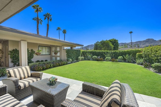 view of yard with a mountain view, outdoor lounge area, and a patio