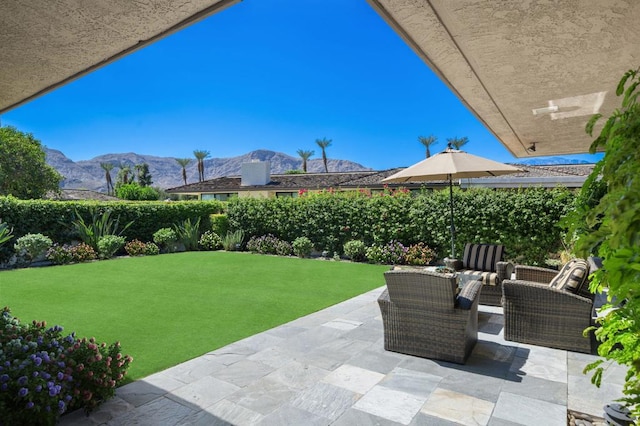 view of patio with a mountain view and an outdoor living space