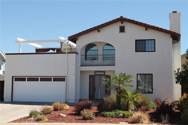 mediterranean / spanish-style home with a garage, a chimney, driveway, and stucco siding