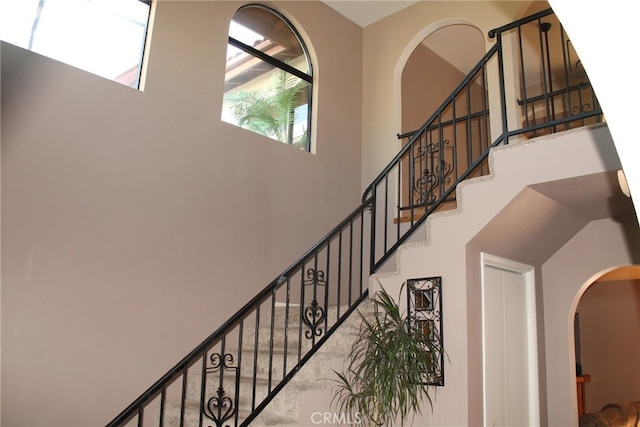 stairway featuring a high ceiling