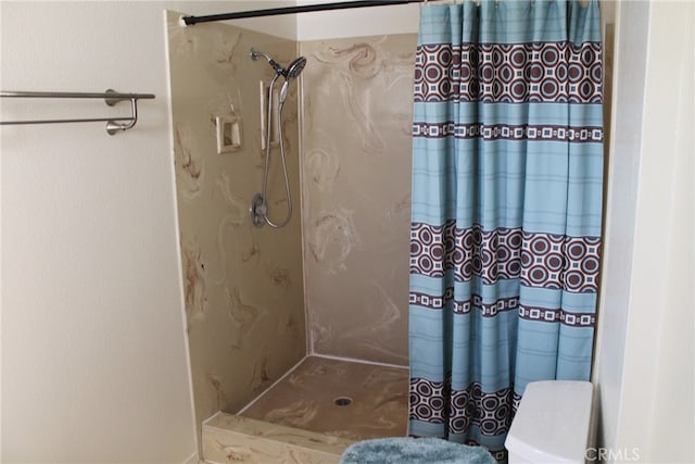 bathroom with toilet and a shower with shower curtain