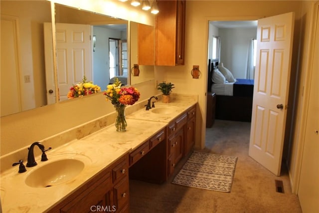 full bath featuring double vanity, visible vents, and a sink