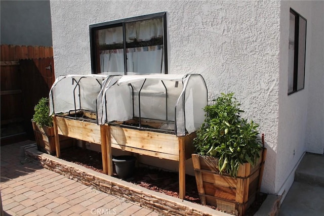 exterior details with fence and stucco siding