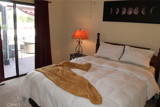 carpeted bedroom featuring access to outside