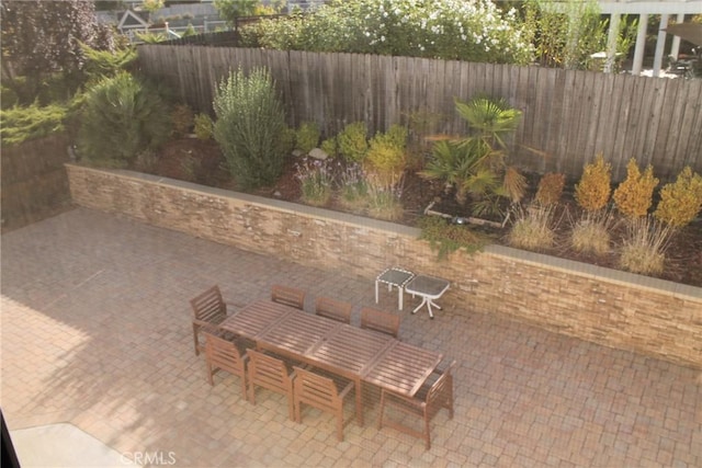 view of patio / terrace featuring fence and outdoor dining space