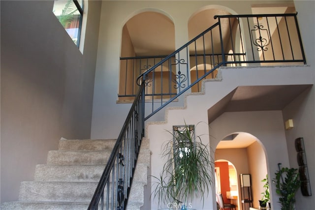 staircase featuring a high ceiling