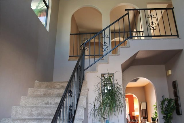 stairway featuring a high ceiling