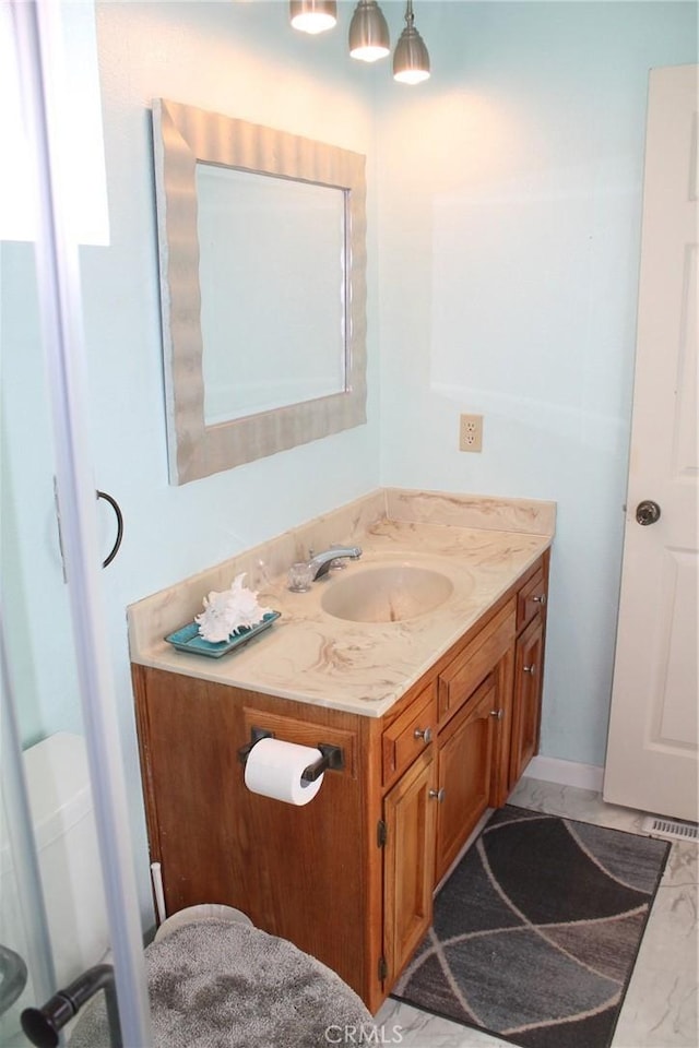bathroom featuring vanity and marble finish floor
