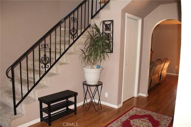 stairs featuring hardwood / wood-style flooring