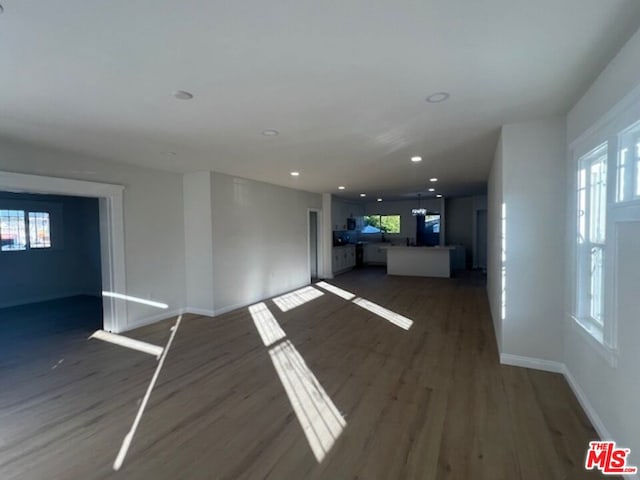 unfurnished living room with dark hardwood / wood-style floors