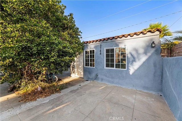 view of side of home featuring a patio area