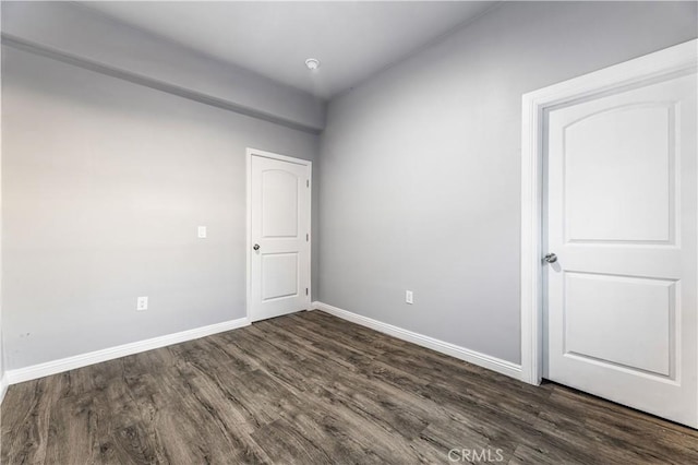 unfurnished room with dark hardwood / wood-style floors