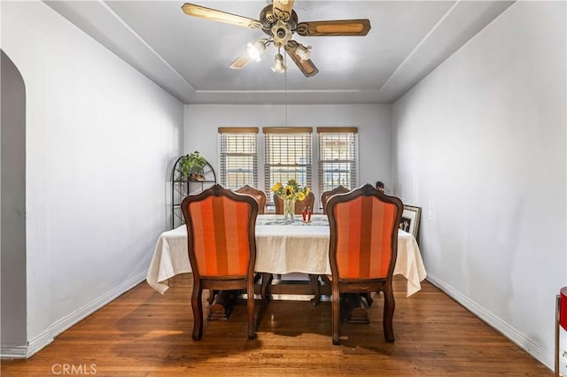 dining room with hardwood / wood-style floors and ceiling fan