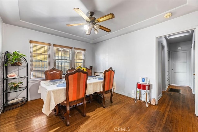 dining area with hardwood / wood-style floors and ceiling fan