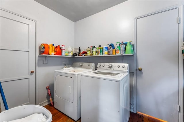 laundry area with washer and clothes dryer and dark wood-type flooring