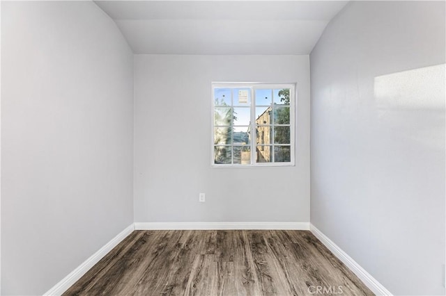 unfurnished room with wood-type flooring and vaulted ceiling