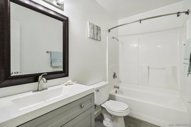 full bathroom featuring wood-type flooring, vanity, toilet, and washtub / shower combination