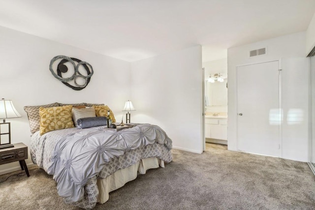 carpeted bedroom featuring ensuite bathroom