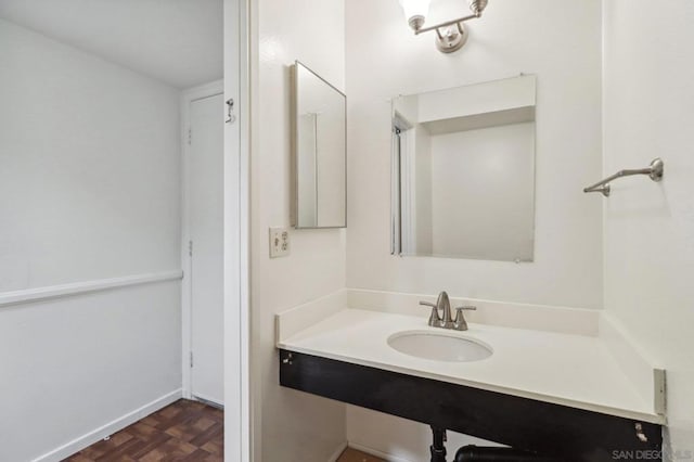 bathroom with parquet flooring and sink