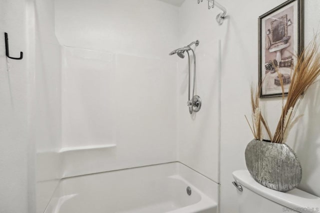 bathroom featuring washtub / shower combination and toilet