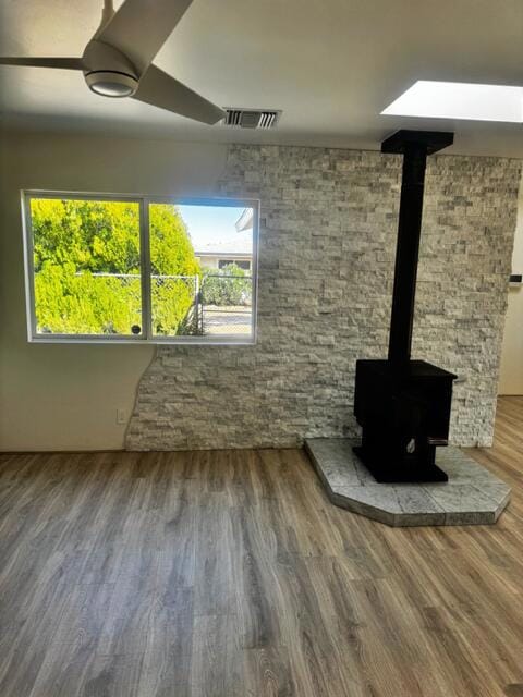 interior space with hardwood / wood-style floors and a wood stove