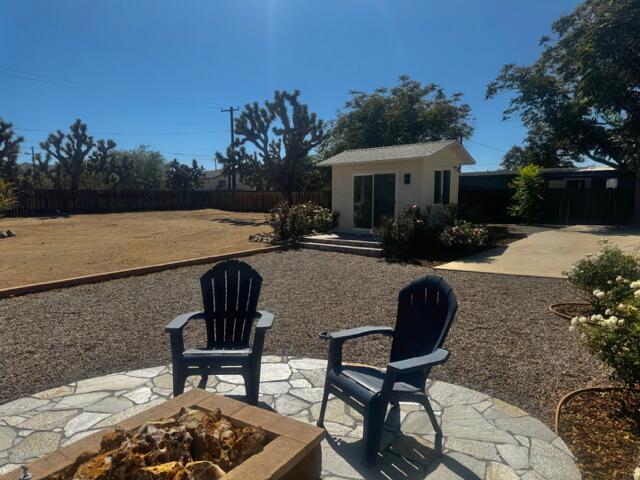 view of patio / terrace featuring an outdoor structure and a fire pit