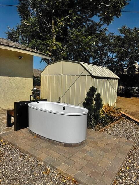 view of patio featuring a storage unit