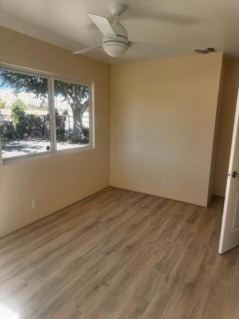 empty room featuring wood-type flooring and ceiling fan