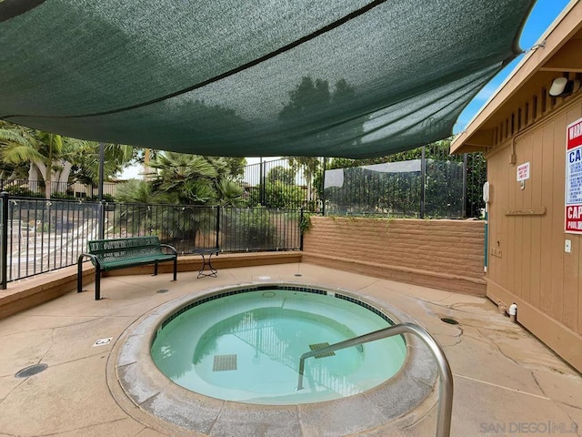 view of pool featuring a patio area and a hot tub