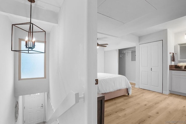 bedroom with a chandelier and light hardwood / wood-style floors