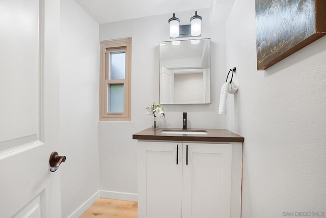 bathroom with vanity and hardwood / wood-style flooring