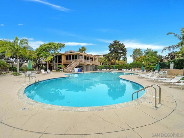 view of swimming pool with a patio area