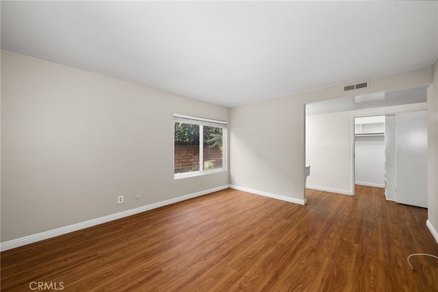 empty room featuring dark hardwood / wood-style flooring