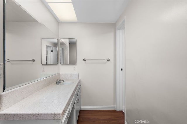 bathroom with hardwood / wood-style flooring and vanity