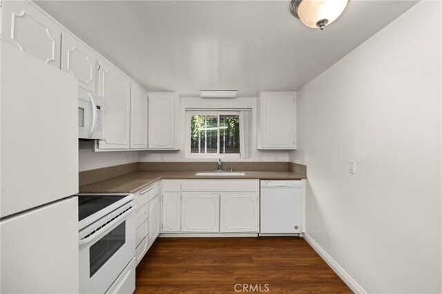 kitchen featuring white cabinetry, sink, white appliances, and dark wood-type flooring