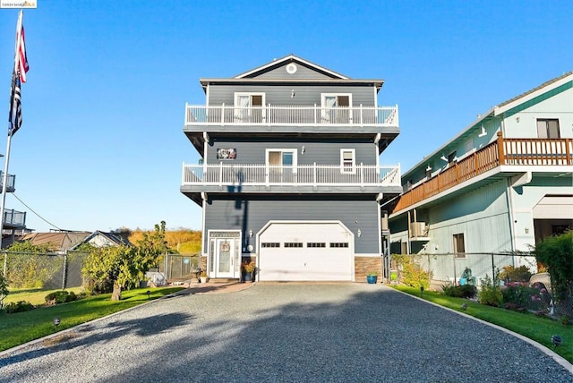 view of front of home with a garage and a balcony